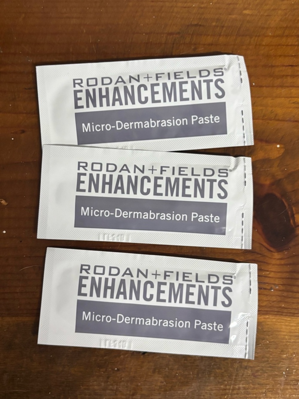 3 sealed Rodan + Fields Enhancements Micro-Dermabrasion Paste samples. O.17 oz